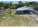 Spacious backyard featuring a metal carport and wood fence, offering ample outdoor space at 11624 Ocklawaha Dr, Leesburg, FL 34788