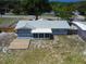 Aerial view of the home with a wooden deck and screened porch at 11624 Ocklawaha Dr, Leesburg, FL 34788