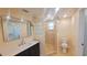 Updated bathroom featuring a vanity, toilet, and a glass block shower stall at 11624 Ocklawaha Dr, Leesburg, FL 34788