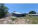 Backyard view of the detached garage with access to the main house and yard at 11624 Ocklawaha Dr, Leesburg, FL 34788
