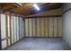 Empty garage with unfinished wood walls and concrete floor at 11624 Ocklawaha Dr, Leesburg, FL 34788