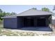Detached garage and carport featuring a drive-through design and ample parking space at 11624 Ocklawaha Dr, Leesburg, FL 34788