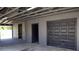 Spacious garage interior featuring a large garage door and open access to the backyard at 11624 Ocklawaha Dr, Leesburg, FL 34788