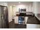 Bright kitchen featuring stainless steel refrigerator and modern appliances and white cabinetry at 11624 Ocklawaha Dr, Leesburg, FL 34788