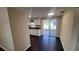 Bright kitchen featuring white cabinetry, dark countertops, and seamless access to the screened lanai at 11624 Ocklawaha Dr, Leesburg, FL 34788