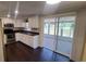 Kitchen with white cabinets, stainless steel appliances, and a sliding glass door to the outside at 11624 Ocklawaha Dr, Leesburg, FL 34788