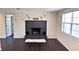 Cozy living room with a striking black brick fireplace and dark hardwood floors at 11624 Ocklawaha Dr, Leesburg, FL 34788