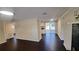 Spacious living area with wood flooring connecting to a bright kitchen and sliding glass doors at 11624 Ocklawaha Dr, Leesburg, FL 34788