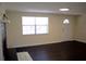 Comfortable living room with wood floors, modern lighting, and a view of the front yard at 11624 Ocklawaha Dr, Leesburg, FL 34788