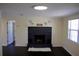 Bright living room featuring a black brick fireplace, dark wood floors, and a view to other rooms at 11624 Ocklawaha Dr, Leesburg, FL 34788