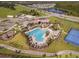 Aerial view of the community's pool, clubhouse, playground, and tennis court amenities at 11982 Travel Aly, Orlando, FL 32832