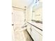 Bathroom featuring black hardware, single vanity, white tile backsplash, and tile floors at 11982 Travel Aly, Orlando, FL 32832