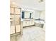 Bathroom featuring double sinks, framed shower, a soaking tub and tile flooring at 11982 Travel Aly, Orlando, FL 32832
