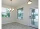 Bright dining area featuring a chandelier and large windows for ample natural light at 11982 Travel Aly, Orlando, FL 32832