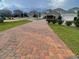 Long brick driveway leads to homes in quiet suburban neighborhood at 11982 Travel Aly, Orlando, FL 32832