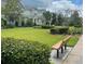 A view of well maintained landscaping and a bench to enjoy the outdoors at 11982 Travel Aly, Orlando, FL 32832