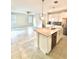 Open kitchen and living area featuring a kitchen island with sink and stainless steel appliances at 11982 Travel Aly, Orlando, FL 32832