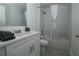 Bathroom featuring white cabinets, marble shower and grey accent towels at 1208 Castleport Rd, Winter Garden, FL 34787