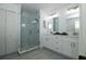 Bathroom featuring glass shower, double vanity and white cabinets at 1208 Castleport Rd, Winter Garden, FL 34787