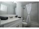 Bright bathroom featuring modern vanity, shower with curtain, and toilet at 1208 Castleport Rd, Winter Garden, FL 34787