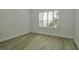 Clean bedroom with wood-look flooring and shuttered windows for privacy at 1208 Castleport Rd, Winter Garden, FL 34787