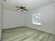 Neutral bedroom showcasing wood-look flooring, one window and a ceiling fan at 1208 Castleport Rd, Winter Garden, FL 34787