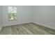 Clean bedroom with wood-look flooring with a sunny window view at 1208 Castleport Rd, Winter Garden, FL 34787