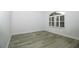 Bright bedroom featuring luxury vinyl plank flooring and a large window with plantation shutters at 1208 Castleport Rd, Winter Garden, FL 34787