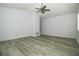 Bright room with wood-look flooring, ceiling fan, and closet for ample storage at 1208 Castleport Rd, Winter Garden, FL 34787