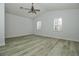 Spacious bedroom featuring two shuttered windows and wood-look flooring at 1208 Castleport Rd, Winter Garden, FL 34787