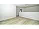 Open bonus room with fresh paint, neutral walls, modern baseboards, and gray wood-look floors at 1208 Castleport Rd, Winter Garden, FL 34787