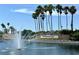 Stoneybrook West entrance with a fountain, lush landscaping, and tall palm trees against a blue sky at 1208 Castleport Rd, Winter Garden, FL 34787