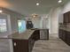 Open-concept kitchen island featuring granite countertops, stainless steel appliances, and views to living area at 1208 Castleport Rd, Winter Garden, FL 34787