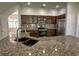 Well-appointed kitchen featuring stainless steel appliances, granite countertops, and dark wood cabinetry at 1208 Castleport Rd, Winter Garden, FL 34787