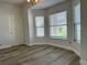 Bright living room featuring large windows, new flooring, and ample natural light at 1208 Castleport Rd, Winter Garden, FL 34787