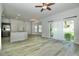 Open-concept living room featuring stainless steel appliances, breakfast bar and sliding glass doors at 1208 Castleport Rd, Winter Garden, FL 34787