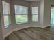 Sunlit living room with new floors, large windows, and a neutral color palette at 1208 Castleport Rd, Winter Garden, FL 34787