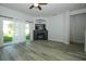 Bright living room with a fireplace and sliding glass doors to the backyard at 1208 Castleport Rd, Winter Garden, FL 34787
