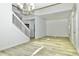 Open living room featuring new flooring, white walls, and stairs at 1208 Castleport Rd, Winter Garden, FL 34787