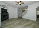 Cozy living room with a fireplace and stairway featuring modern luxury vinyl plank flooring at 1208 Castleport Rd, Winter Garden, FL 34787