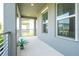 Outdoor balcony area with columns, railings, and a view of the neighborhood at 12259 Bracco St, Winter Garden, FL 34787