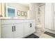Bright bathroom with double vanity, white cabinets, and shower at 12259 Bracco St, Winter Garden, FL 34787