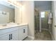 Bright bathroom with double vanity, modern fixtures, and a glass-enclosed shower at 12259 Bracco St, Winter Garden, FL 34787
