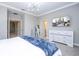 Spacious bedroom featuring a large dresser, mounted television, and modern decor at 12259 Bracco St, Winter Garden, FL 34787