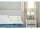 Close up on the bed in the Primary suite featuring textured headboard and upscale nightstand at 12259 Bracco St, Winter Garden, FL 34787