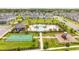 An aerial view of neighborhood amenities showcasing a community pool, basketball court and playground at 12259 Bracco St, Winter Garden, FL 34787