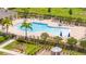Resort-style community pool with ample lounge seating, umbrellas and lush landscaping at 12259 Bracco St, Winter Garden, FL 34787