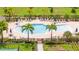 Gorgeous community pool surrounded by many lounge chairs, tables and umbrellas at 12259 Bracco St, Winter Garden, FL 34787