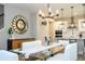 Contemporary dining area with elegant chandelier and an open view into the kitchen at 12259 Bracco St, Winter Garden, FL 34787