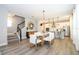 Bright dining area with modern table, stairs, and a view of the kitchen at 12259 Bracco St, Winter Garden, FL 34787
